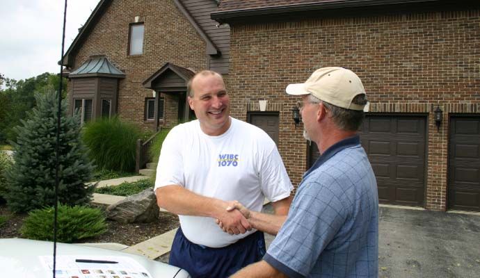 Americrawl professional team shaking hand with happy client