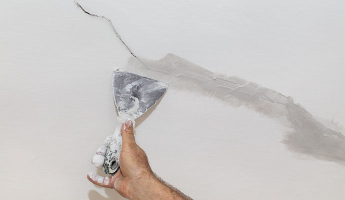 professional worker fixing wall crack