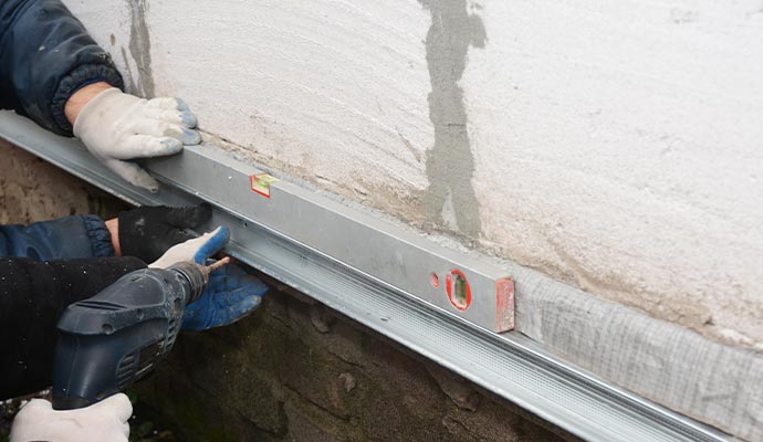 Professional worker repairing foundation