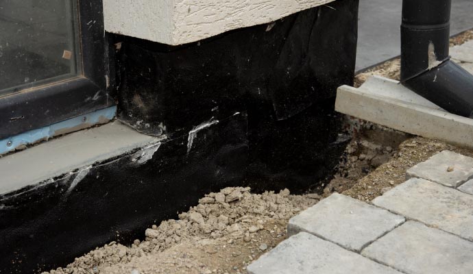 Loose soil near house foundation wall Loose soil near house foundation wall