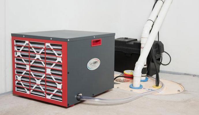 A dehumidifier installed on a vapor barrier in an encapsulated crawl space